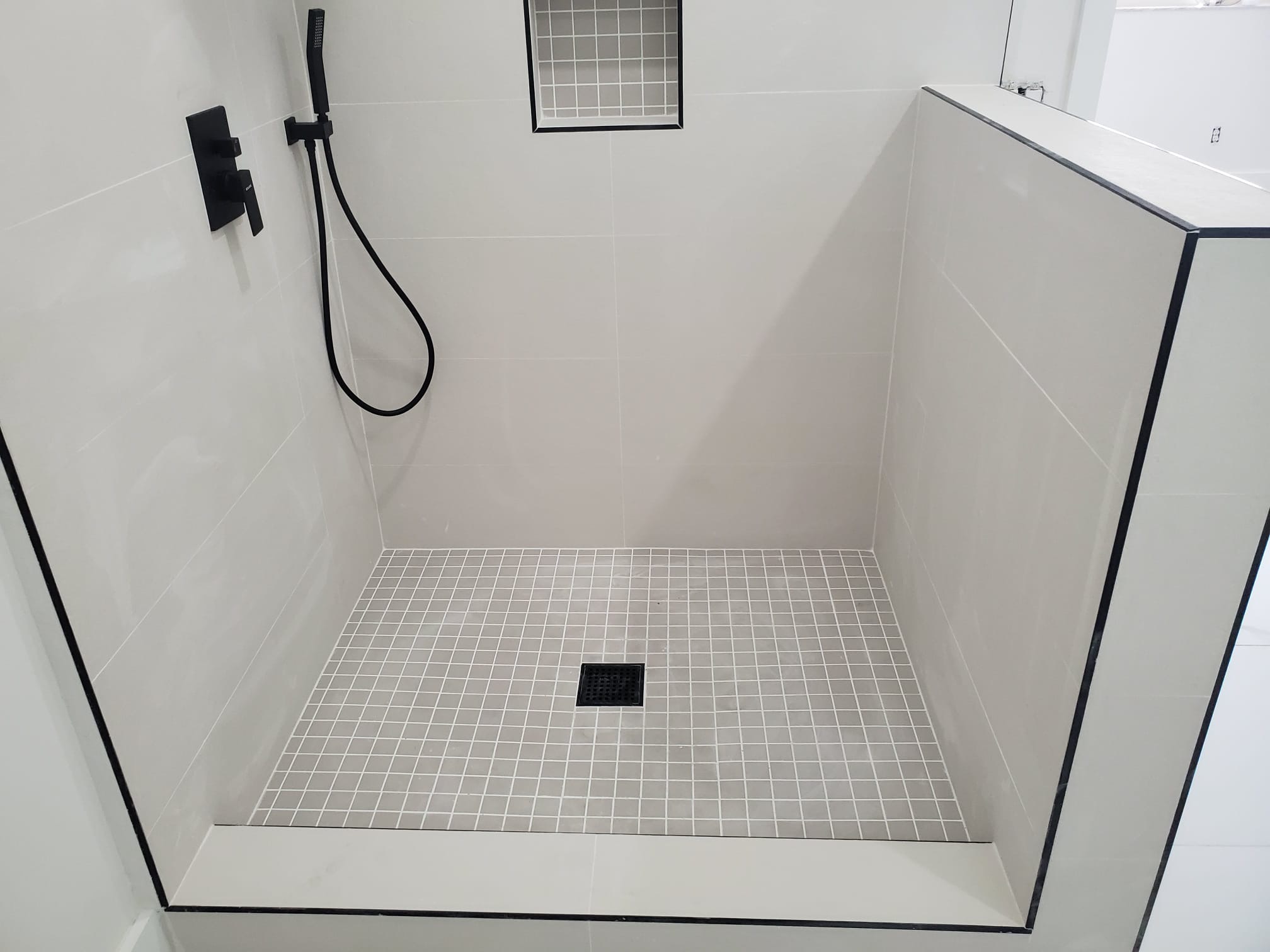 Close bathroom remodeling detail showing precise tile and fixtures